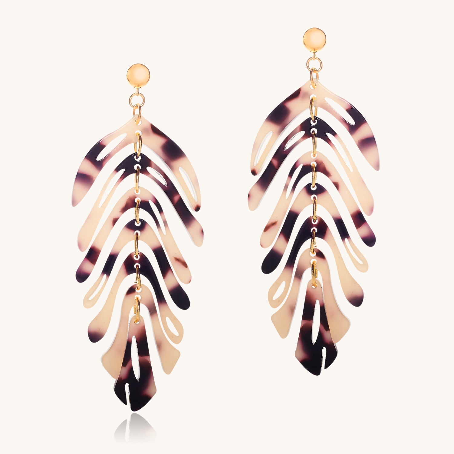 Tortoiseshell leaf-shaped earrings on a white background