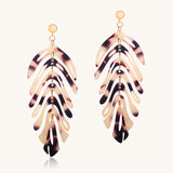 Tortoiseshell leaf-shaped earrings on a white background