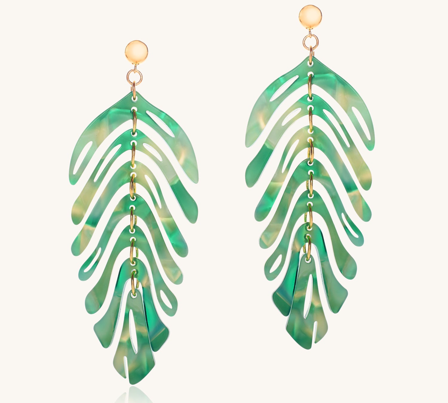 Green leaf-shaped earrings on a white background