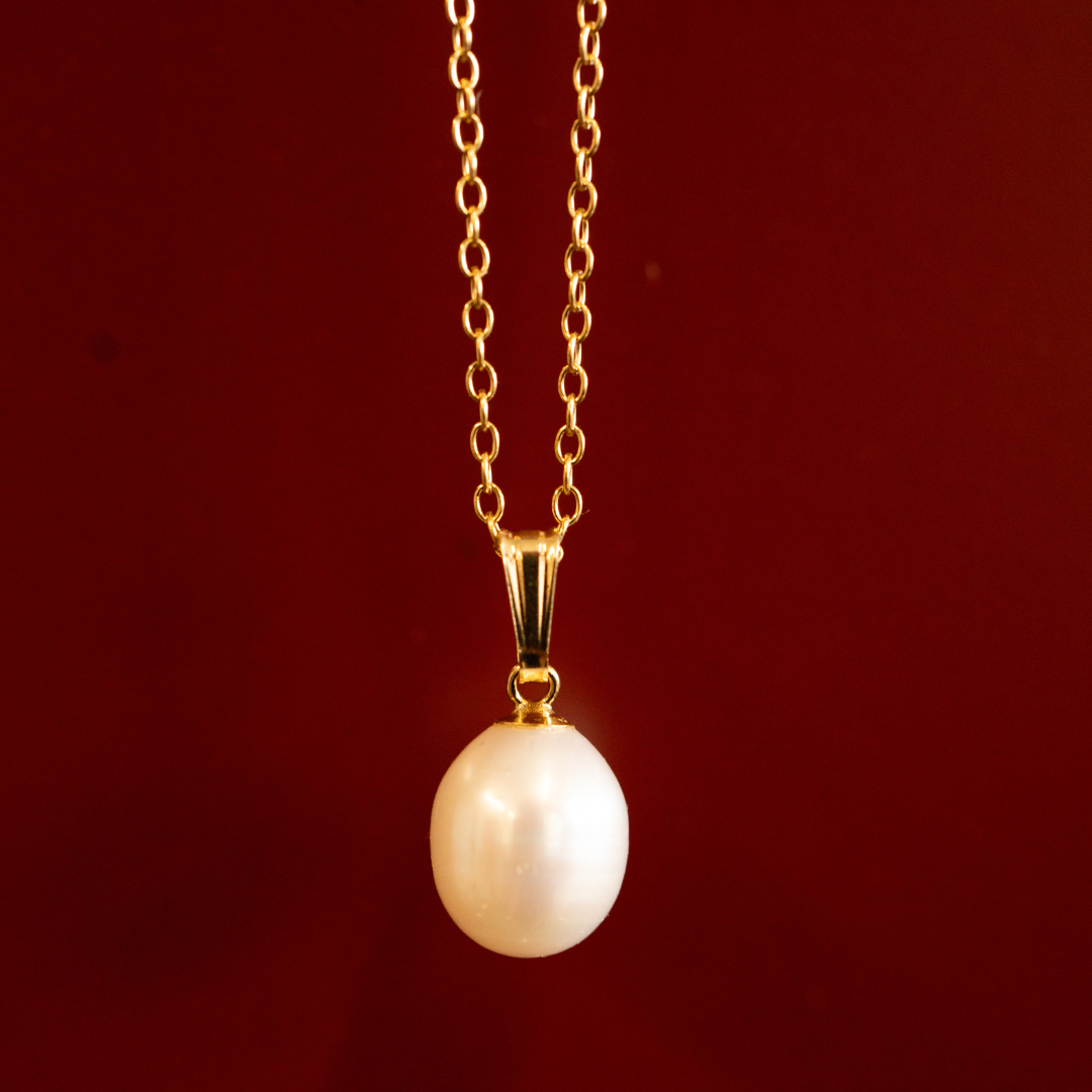 fresh water pearl necklace on burgundy background