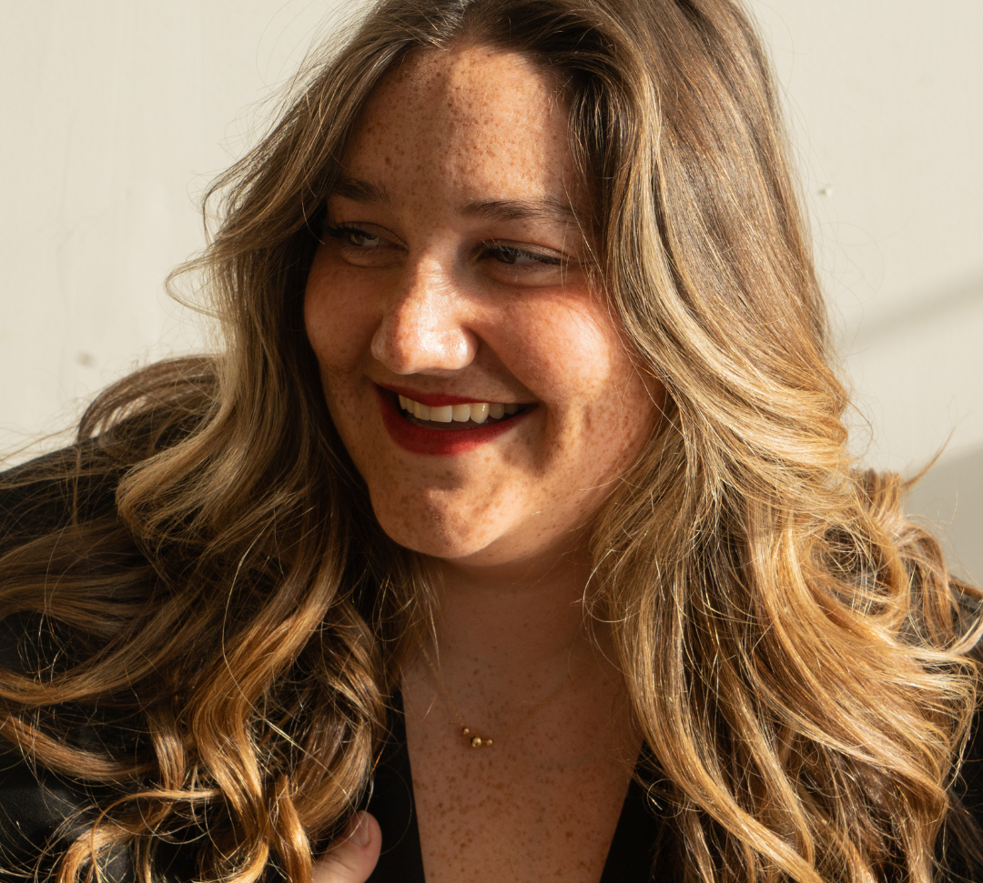 Model wearing gold filled ball necklace with black blazer