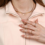 model posing with rings and hand to her chest