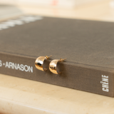 hammered earrings styled on a book